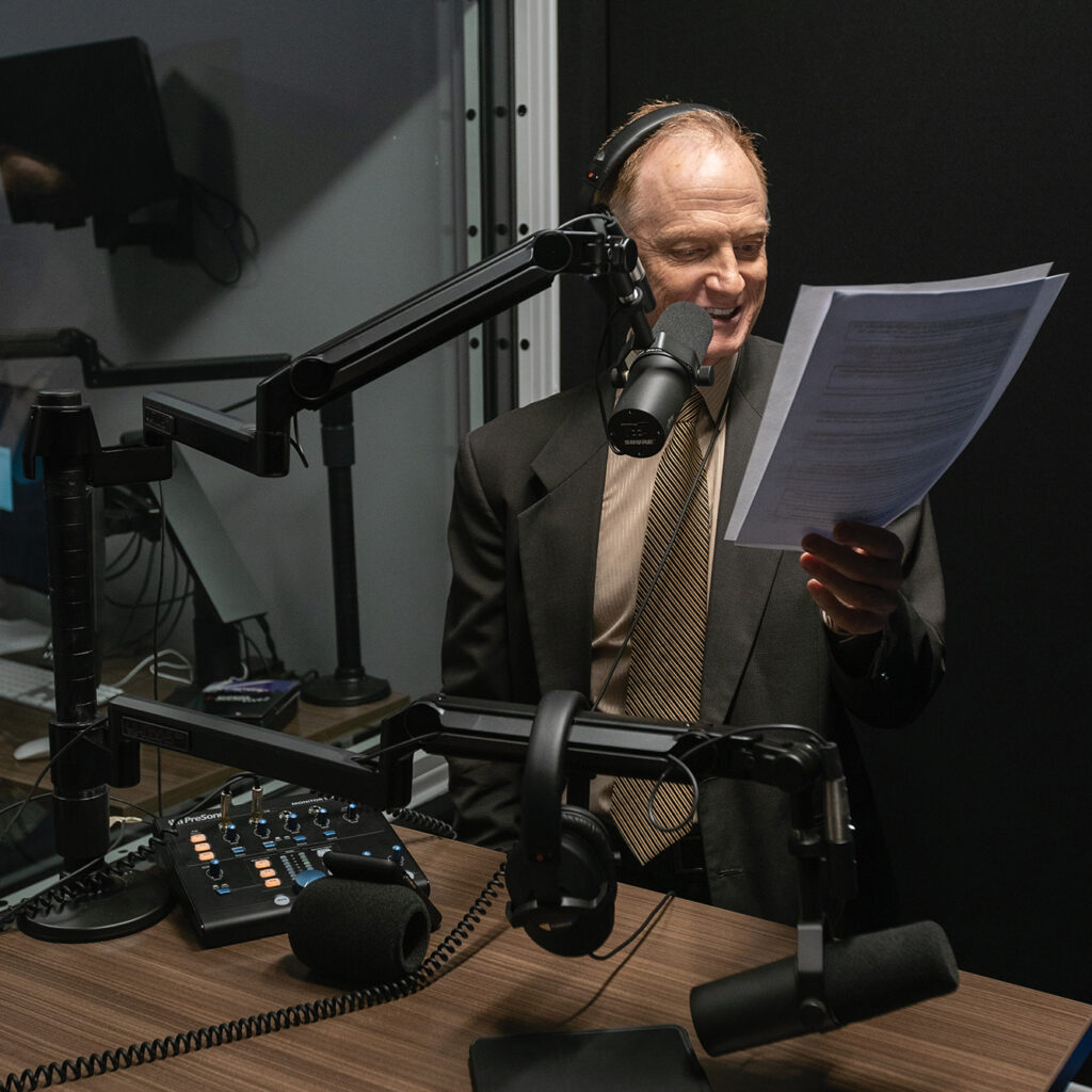 John recording a voice track in the audio control room