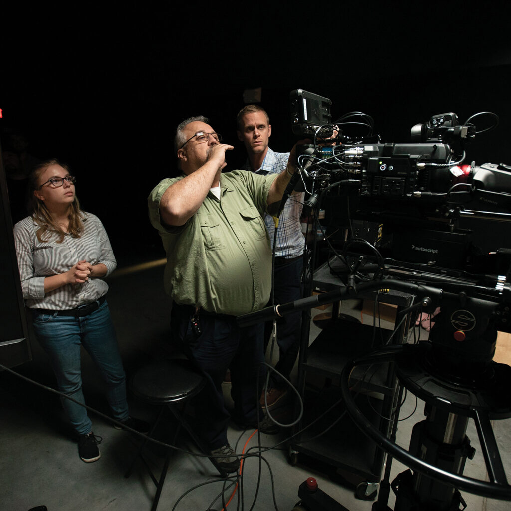 film crew working on set in the studio